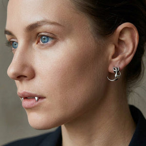 Flame Claw Sterling Silver Stud Earrings, worn correctly through one visible earlobe in three-quarter profile