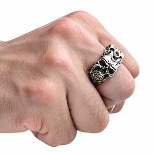 Sterling silver flame skull ring worn on a fair-skinned hand