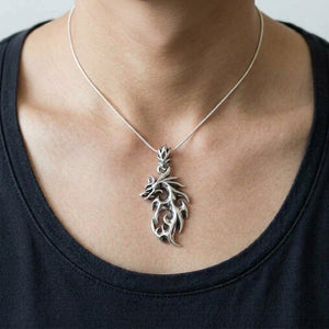 Openwork Flaming Dragon Sterling Silver Pendant worn on a fine chain, showing the neck and collarbones