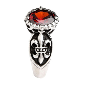 Profile view of sterling silver gothic ring displaying fleur de lis emblem and red stone elevation