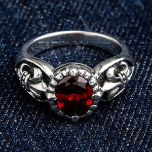 Front view of vintage-inspired red stone ring with fleur de lis emblem in sterling silver