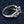 Three quarter view of fleur de lis red stone ring highlighting gothic scrollwork and gemstone setting