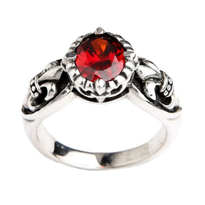 Gothic sterling silver ring with brilliant red stone and fleur de lis design on white background