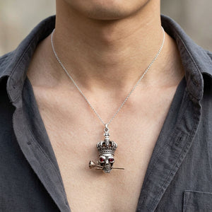Garnet-Eye Crown Skull and Rose Silver Pendant, worn on the neck with collarbones, shoulders and upper chest visible