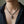 Garnet-Eye Skull Sterling Silver Necklace, worn on the neck with collarbones, shoulders and upper chest visible
