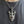 Garnet Flame Skull Sterling Silver Pendant, worn chest detail