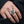 Garnet Fleur-de-Lis Shield Sterling Silver Ring worn on a hand