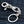 Schedel sleutelhanger van .925 sterling zilver met granaatogen, voorkant van de sluiting op denim