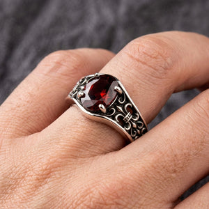 Synthetic Garnet Fleur-de-Lis Sterling Silver Ring, worn on an adult model