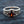 Synthetic Garnet Fleur-de-Lis Sterling Silver Ring, ring on blue fabric