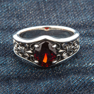 Synthetic Garnet Fleur-de-Lis Sterling Silver Ring, ring on blue fabric