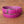 Genuine pink crocodile skin belt with polished silver buckle close-up