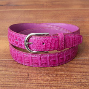 Genuine pink crocodile skin belt with polished silver buckle close-up