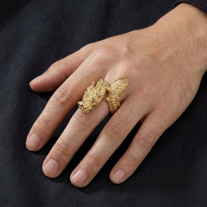 Gold-plated silver dragon ring with horned head and featherlike tail worn on a hand
