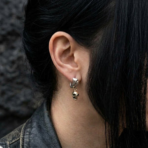 Gold-Plated Skull Sterling Silver Hoop Earrings, worn on an uncovered ear with swept-back hair