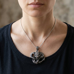 Gothic Dragon Sterling Silver Pendant, worn at the neck on an adult model; chain is styling context