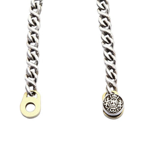 Guadalupe Silver and Brass Medallion Bracelet showing the decorated clasp cap opposite its receiving end.