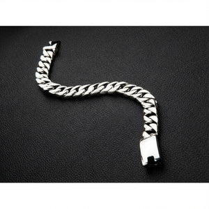 Handcrafted sterling silver chain bracelet displayed in S curve showing flexibility and polished links