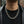 Heavyweight sterling silver dragon chain necklace worn over a black shirt with a leather jacket