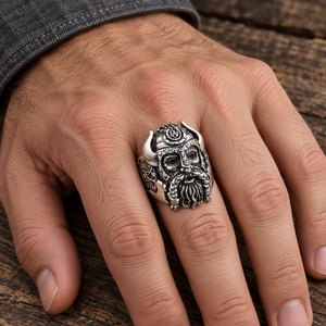 Horned Warrior and Shield Sterling Silver Ring with its horned helmet and beard on an adult hand over wood.