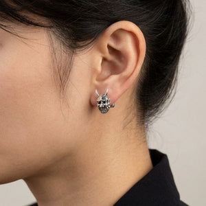 Horned Oni Mask Sterling Silver Stud Earrings, worn at the ear on an adult model