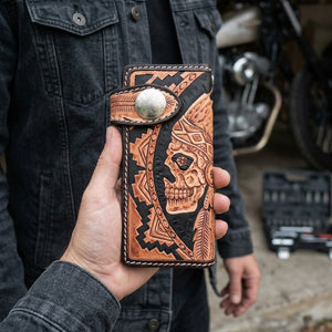 Indian Skull Brown Leather Biker Wallet held vertically in an adult hand