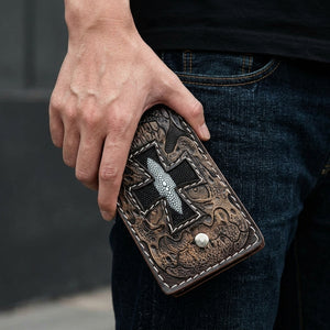 Iron Cross Stingray Leather Biker Wallet, held closed at hip level with the decorated front visible