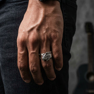 Adjustable koi fish silver ring worn on the original model hand against dark denim