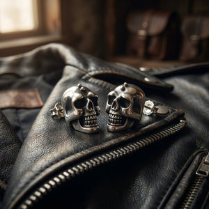 Large Skull Sterling Silver Stud Earrings, skull studs resting on leather