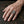 Lattice gothic cross silver ring worn on a hand, showing the ring face and band