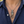 Lion Door-Knocker Sterling Silver Pendant with its engraved mouth ring over a navy shirt.