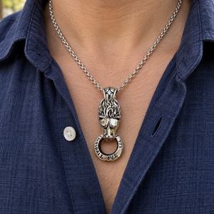 Lion Door-Knocker Sterling Silver Pendant with its engraved mouth ring over a navy shirt.