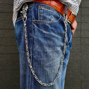 Maltese Cross silver wallet chain clipped to blue jeans, showing the full drape and clasps