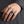 Mechanic flame skull silver ring worn on a hand, showing the ring face and band