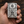 Mexican sugar skull sterling silver Zippo case held over dark wood