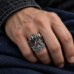 Mjolnir Charm and Scale Sterling Silver Ring with its separate hammer charm on a hand over dark blue cloth.