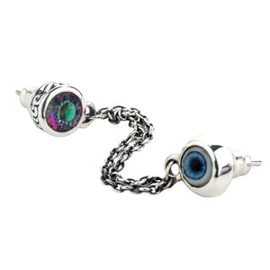 Angled linked eye and topaz studs with their posts visible