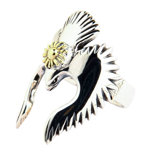 A Native American style bird ring in sterling silver, with artistically outstretched wings and a golden sun symbol.