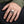 Natural Garnet Eye Sterling Silver Skull Ring worn on an adult hand.