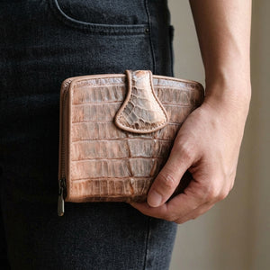 Old Rose Crocodile Tail Snap Wallet held beside the hip