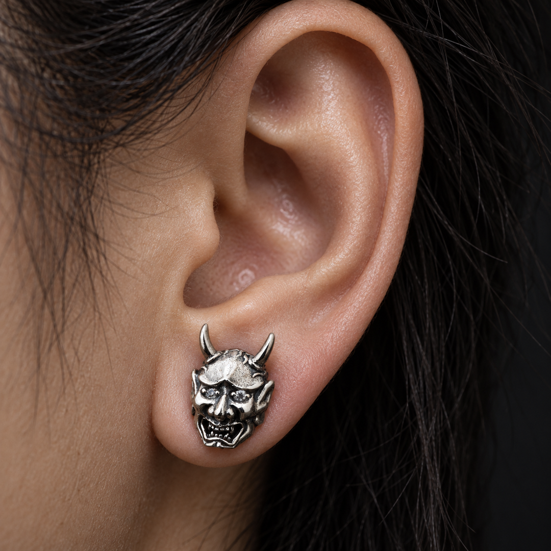 Oni demon diamond-eye sterling silver stud earring worn in earlobe