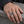 Openwork Gothic 13 Sterling Silver Ring on an adult hand resting on grey stone.