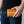 Orange Row Stingray Leather Bifold Wallet, held naturally at hip level