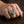 Our Lady of Guadalupe ring worn on a hand, showing the standing figure, gold-toned oval rim and brass side shield