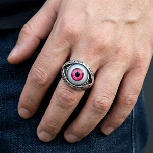 Pink Evil Eye Sterling Silver Gothic Ring, worn on one middle finger in a natural hand close-up