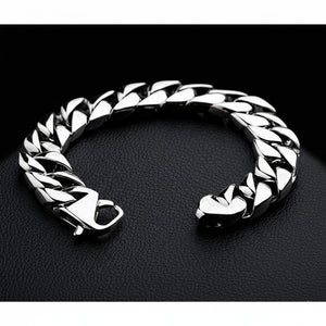 The highly polished 14mm silver curb link bracelet shown in a curve to display the brilliant finish on the links.
