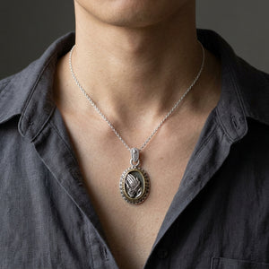 Praying Hands Sterling Silver & Brass Pendant, worn on a neutral styling chain from chin down with collarbones, shoulders and upper chest visible; chain not included