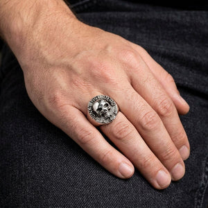 Punk Not Dead skull sterling silver ring worn on a relaxed hand
