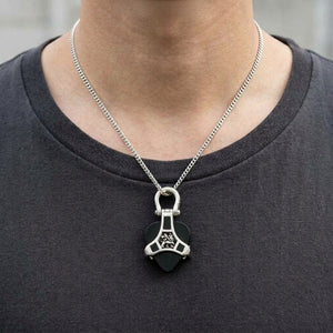 Rasta Lion Silver Guitar Pick Holder Pendant worn on a fine chain, showing the neck and collarbones