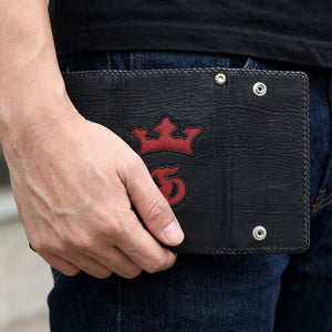 Red Crown Shark and Stingray Leather Biker Wallet, held at hip level